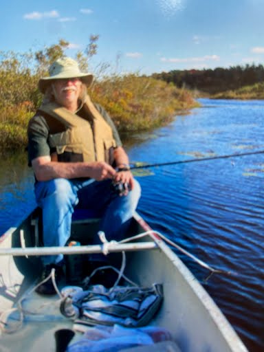 Hilton Everett Moore fishing a river in autumn near his cabin in the Upper Peninsula wilderness of Michigan.